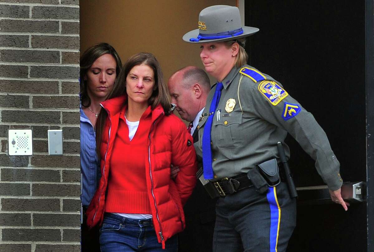 Michelle Troconis is escorted to an awating police vehicle after being arrested and processed at State Police Troop G Headquarters in Bridgeport on Jan. 7.