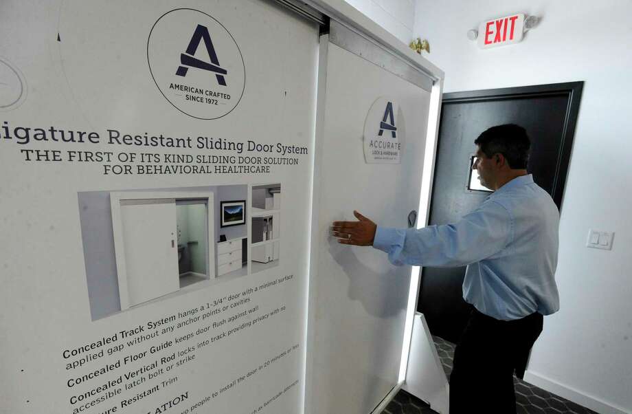 A model of a Ligature Resistant Sliding Door System during a tour of Accurate Lock &amp; Hardware manufacturing facility in Stamford last year. Photo: Matthew Brown / Hearst Connecticut Media / Stamford Advocate