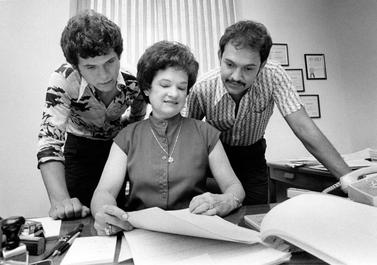 06/19/1979 - Alberto Pena, 19, left, and Fernando De Leon, 25 - the first two males to work as assistant city of Houston secretaries since 1938 - flank their boss, city secretary Anna Russell. They started work this week. Russell said they were the first male applicants for the jobs in her office for as long as she's been there.