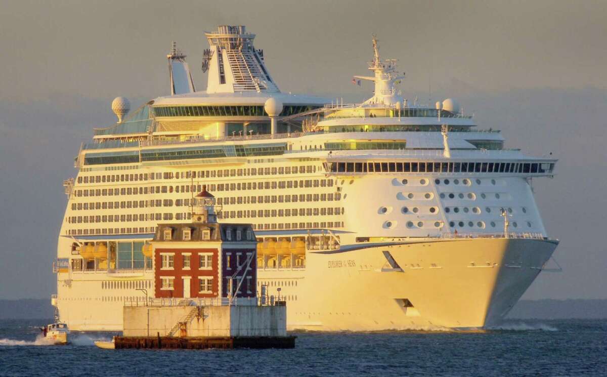 The Royal Caribbean International cruise ship Explorer of the Seas is lit by the sunrise as it passes New London Ledge Lighthouse in Groton, Conn., Saturday Sept. 1, 2007. (AP Photo/The Day, Tim Cook) ** MAGS OUT, NO SALES, INTERNET OUT, MANDATORY CREDIT **