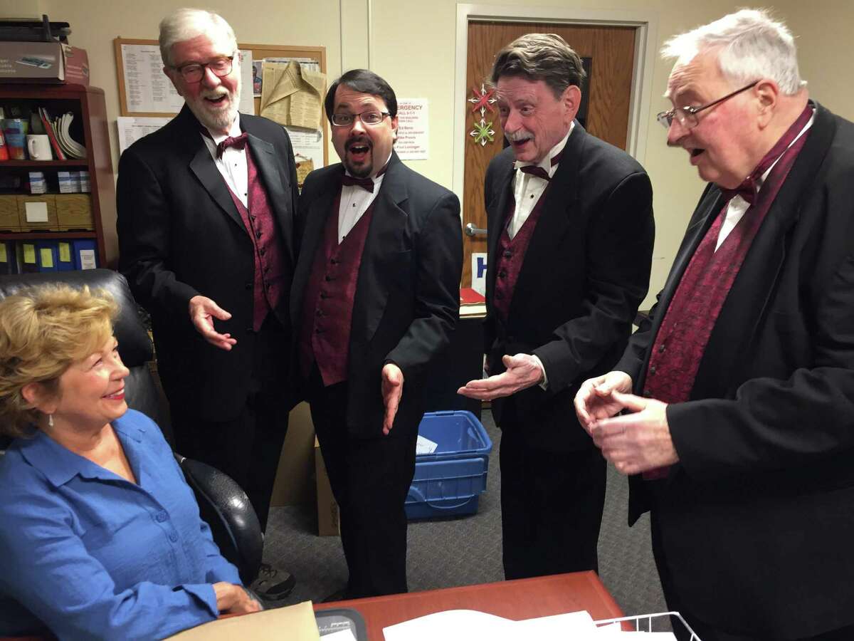 A quartet from the Trumbull-based Coastal Chordsmen serenades Donna Wong of Monroe, preparing for Valentine's Day, Friday, Feb. 14. Quartets will deliver Singing Valentines. A loved one will receive a song plus a chocolate lollipop and rose or a dozen roses. Call 203-816-0462 for more information. Pictured are: Phil Kraft, Darien; Chris Andrade, Fairfield; Richard Allman, Shelton; and Russ Lang, Seymour.