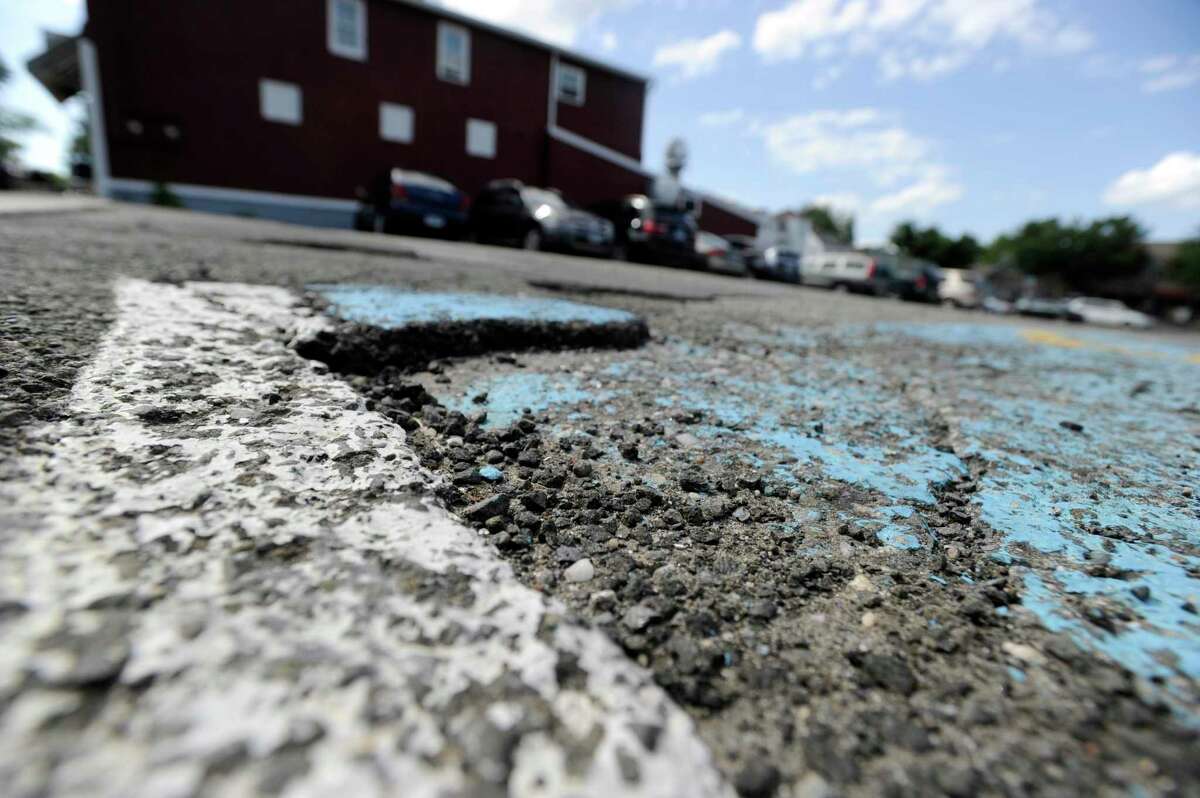 The all-too-common descent of tire into pothole could soon be over for downtown parkers in Ridgefield, Conn. The Board of Selectmen voted Wednesday to award a project that will repair the pothole-ridden Bailey Avenue parking lot and expand the size of its spaces to meet required dimensions. Thursday, August 14, 2014.