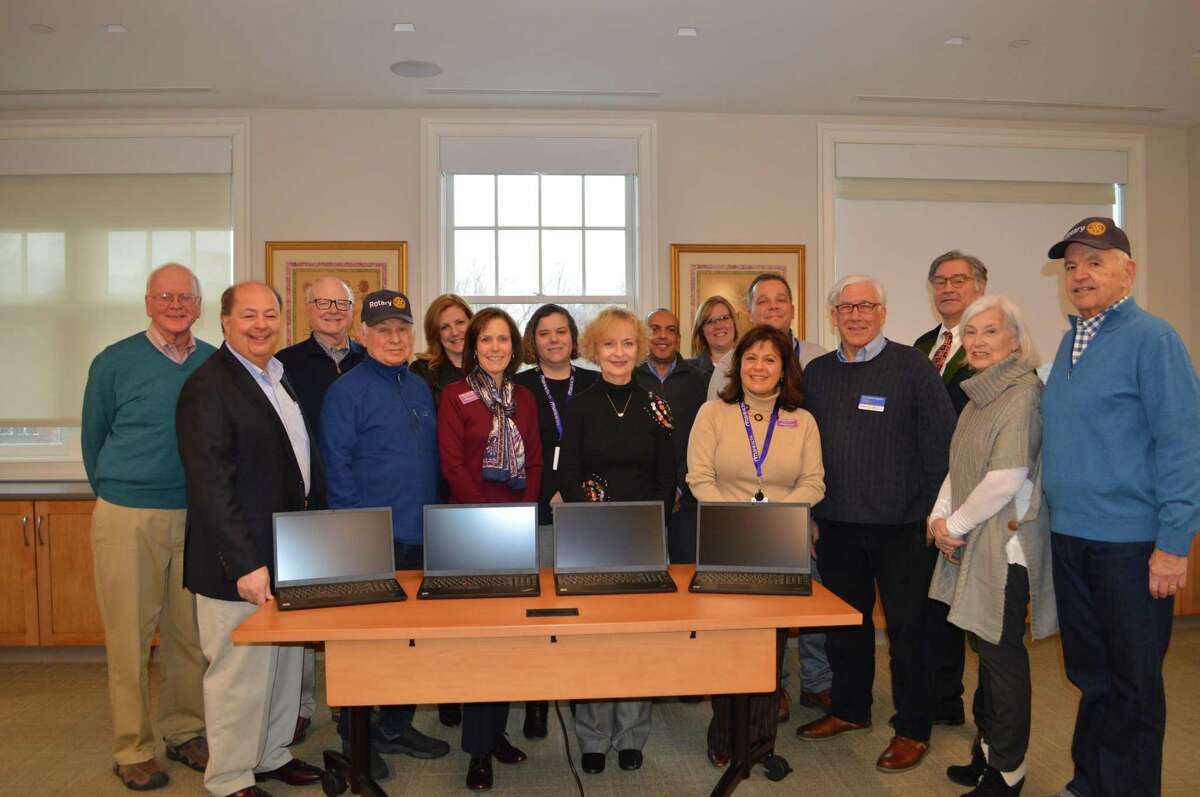 Area Rotarians with members of the RVNAhealth leadership team and the newly purchased laptops: Joe Cleary; Ralph Passarelli; Joel Third; Mike Anderson; Keri Linardi, RVNAhealth; M.J. Heller, RVNAhealth; Gigi Weiss, RVNAhealth; Geri Blair; Mario Boursiquot, RVNAhealth; Melissa Papish, RVNAhealth; Theresa Santoro, RVNAhealth President & CEO; John Apinis, RVNAhealth; Christopher Hoeffel, Rotary District 7980; Robert Herber; Sue Manning; Bill Wyman.