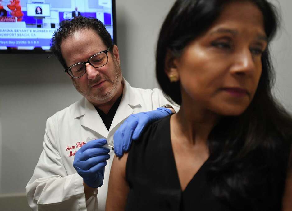 Dr. Steven Heffer administers the flu vaccine at AFC Urgent Care in Fairfield, Conn. on Thursday, February 06, 2020.