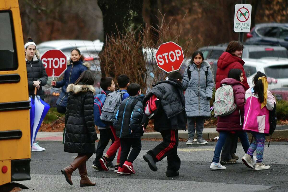 School lets out at Silvermine Elementary School Thursday, February 6, 2020, in Norwalk, Conn. A number of parents, students and staff came out Wednesday night to make pleas to the Planning Commission to fund certain capital projects. In particular, many from the Silvermine community asked the commission to fund a new driveway for the school as the current one cannot support the nine buses that come to the school in addition to parents who drive their kids.