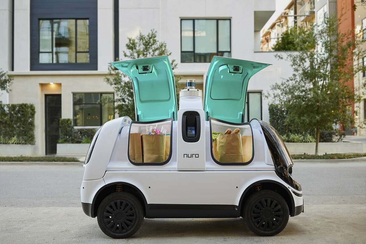 This undated image provided by Nuro in February 2020 shows their self-driving vehicle "R2" carrying bags of groceries. On Thursday, Feb. 6, 2020, the U.S. National Highway Traffic Safety Administration granted temporary approval for Silicon Valley robotics company Nuro to the a low-speed autonomous delivery vehicle, without side and rear-view mirrors and other safety provisions required of vehicles driven by humans. (Nuro via AP)