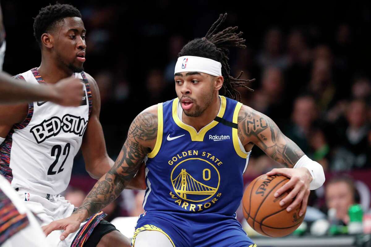 Golden State Warriors guard D'Angelo Russell (0) drives next to Brooklyn Nets guard Caris LeVert (22) during the first half of an NBA basketball game Wednesday, Feb. 5, 2020, in New York. (AP Photo/Kathy Willens)