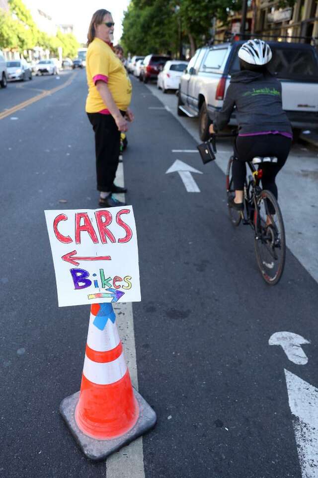 Harry Bower and fellow San Francisco bike riders create a human chain to separate the bike lane from vehicular traffic on Valencia Street in 2017.