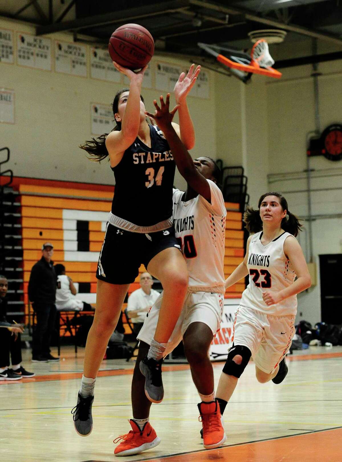 Staples Ariana Gerig (34) puts up a shot against Stamford's Widline Thomas (20) in the first half of an FCIAC girls basketball game at Kuzco Gymnasium in Stamford, Conn. on Feb. 6, 2020.