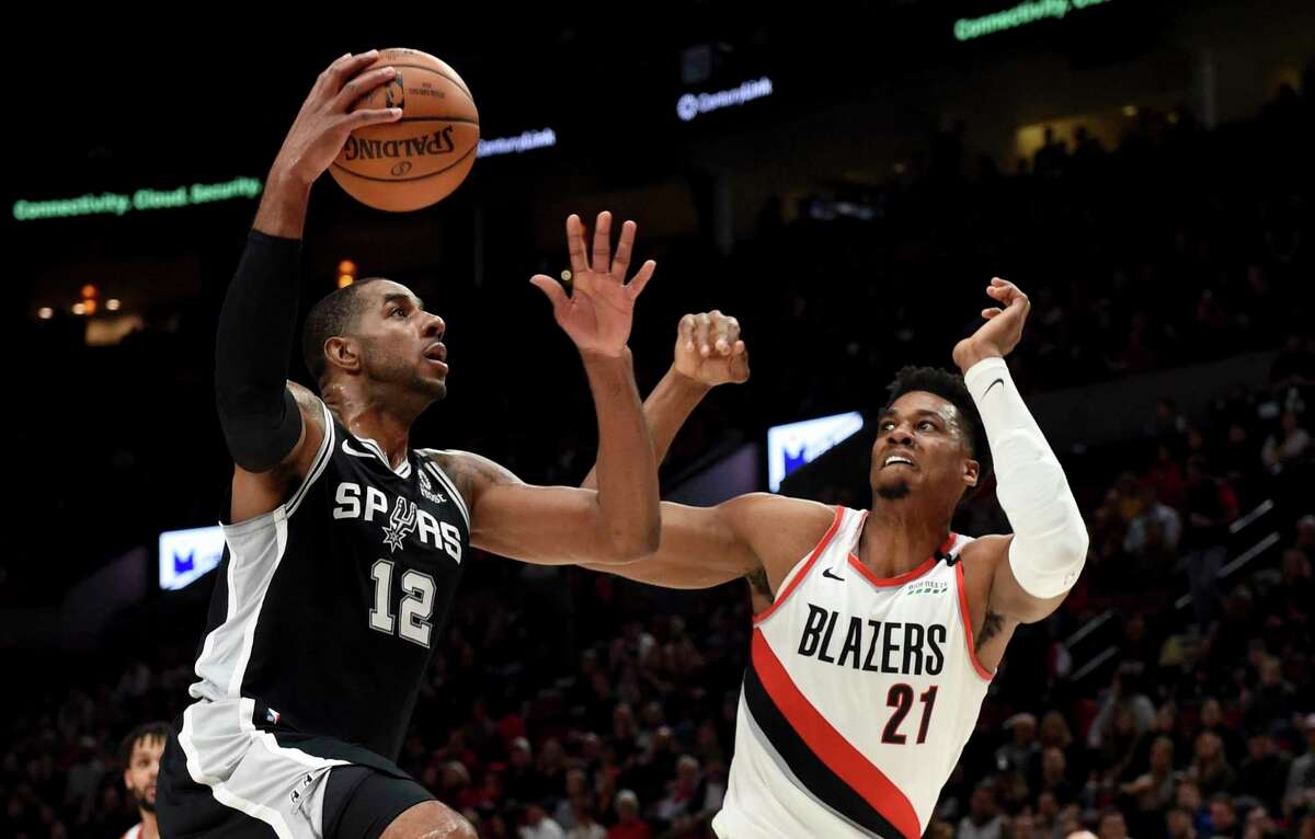 LaMarcus Aldridge goes to the hoop against Portland center Hassan Whiteside, who had a monster game on the boards with 23 rebounds.