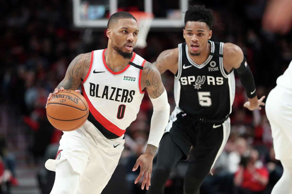 Dejounte Murray chases Blazers All-Star Damian Lillard. The Spurs held the red-hot Lillard to 26 points, only his second time under 30 since Jan. 15. But they had little answer for his Portland teammates.