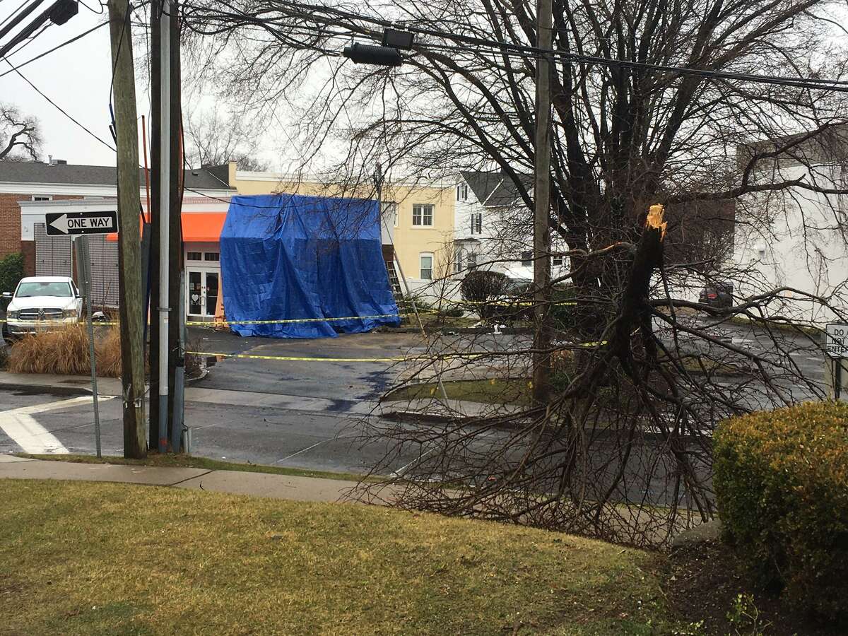 A large blue tarp covers the damage at Chocoylatte Gourmet on Friday morning after the shop was hit by a car late Thursday night.