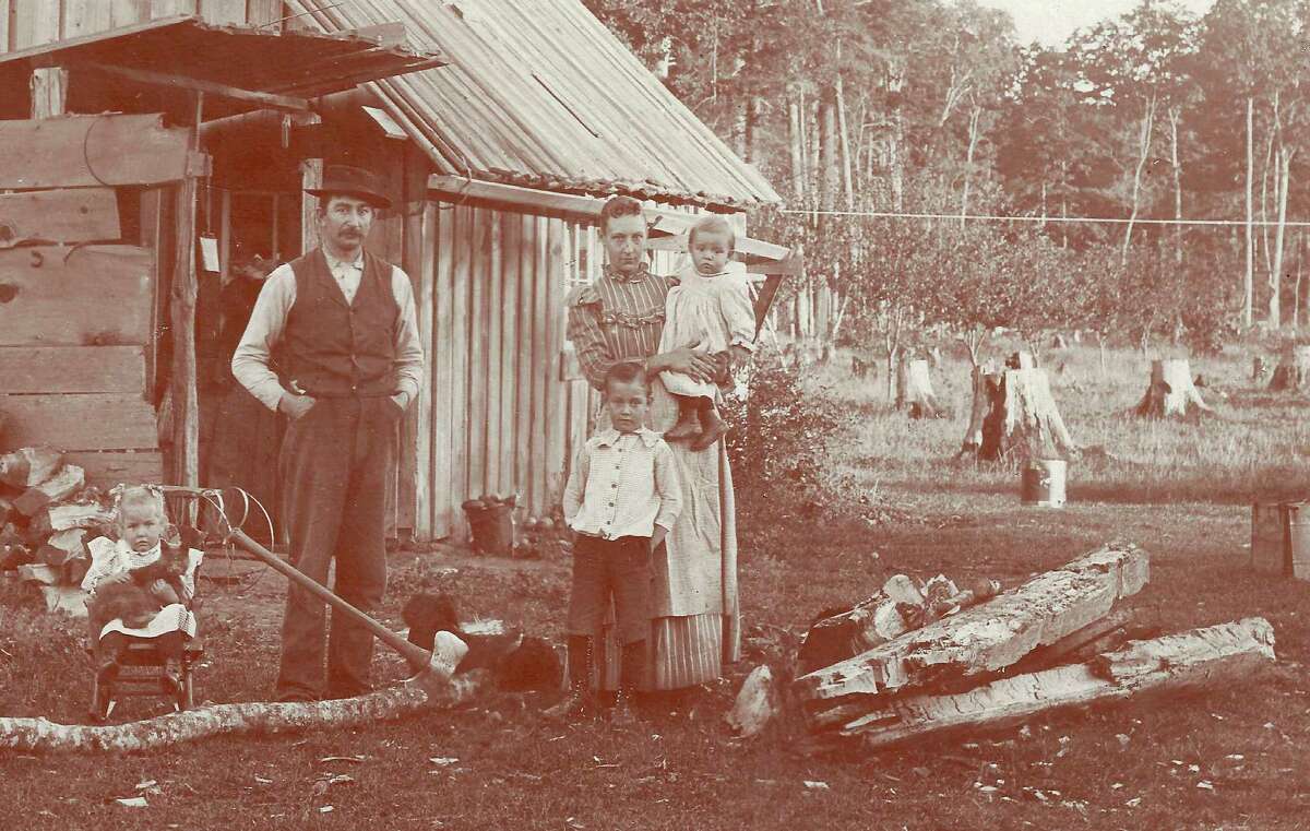 Richard and Cora Ely and first living quarters on their homestead on Ely Rd., c. 1895, where stumps are yet to be cleared. Children are Walter, Vesta, and Andrew. (Courtesy Photo)