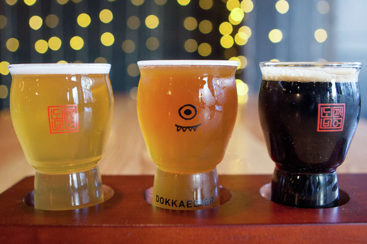 A flight of three Dokkaebier beers, including (L-R) a pilsner made with bamboo, a witbier brewed with omija berry and gochugaru chili, and a stout made with cardamom and green peppercorn.