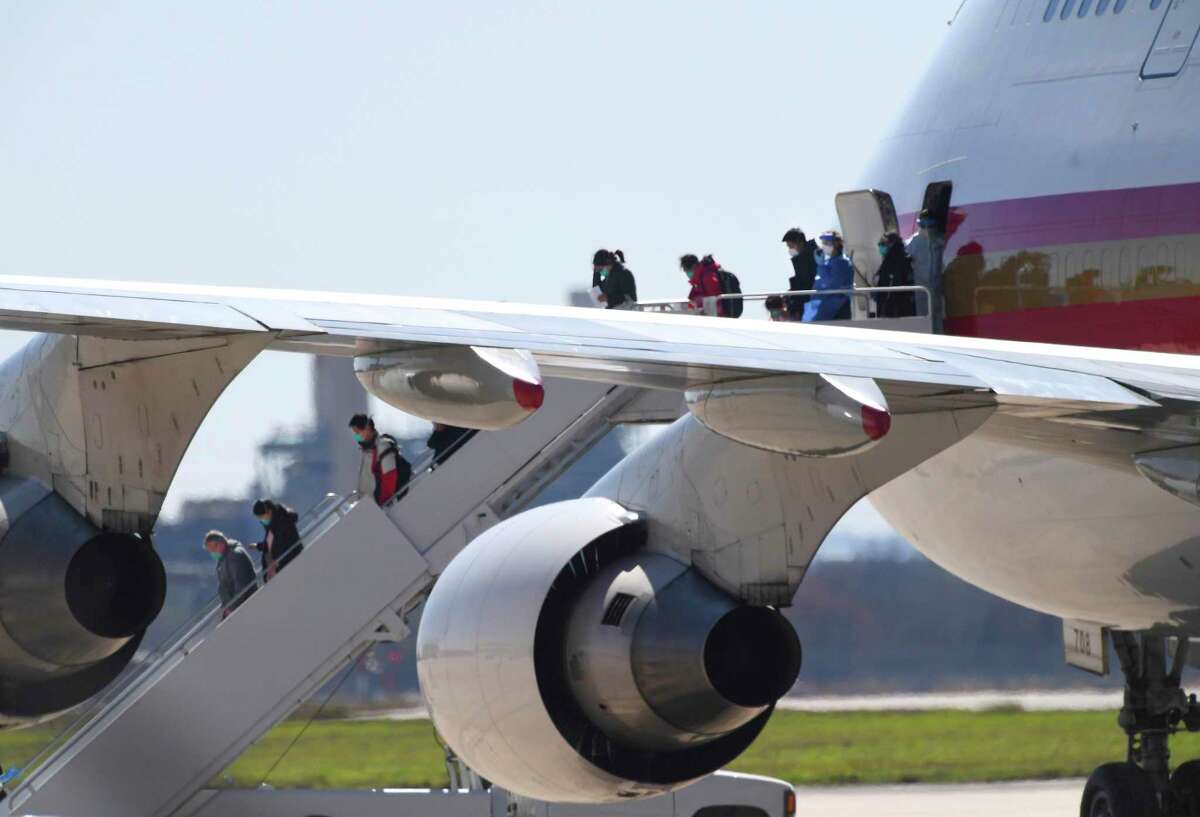 People at risk of carrying the coronavirus arrive at Joint Base San Antonio-Lackland aboard a chartered Boeing 747 on Friday, Feb. 7, 2020.