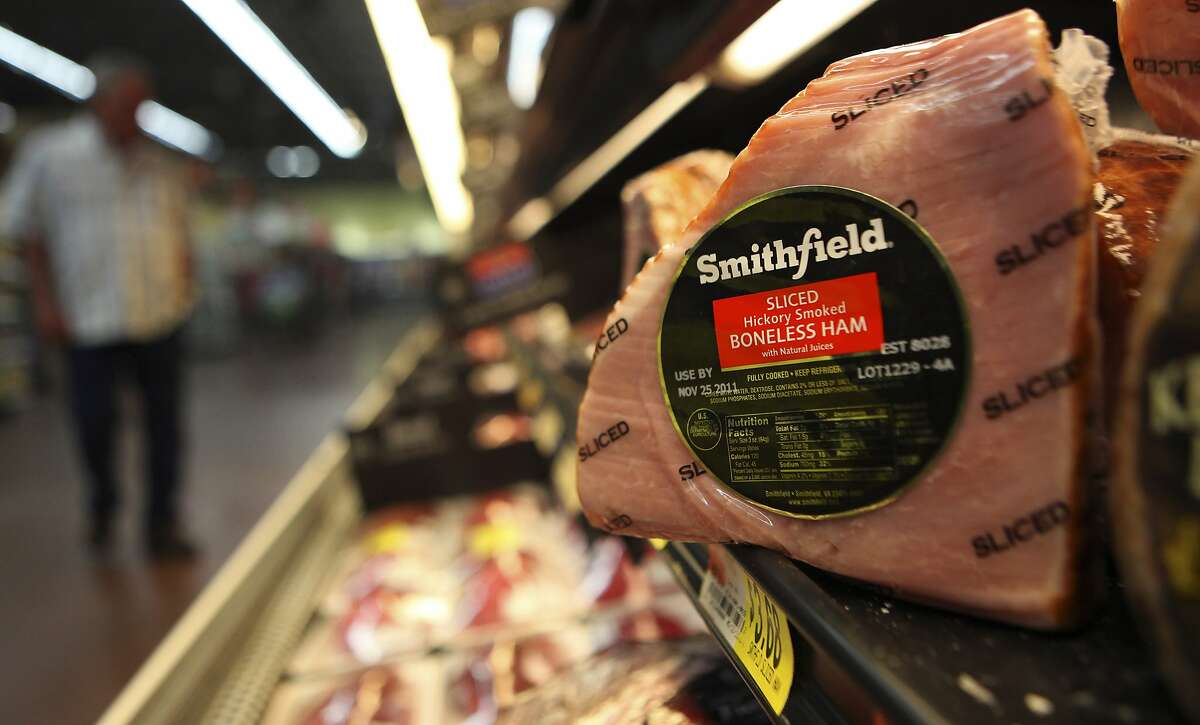 In this Sept. 6, 2011 file photo, shows a Smithfield ham at a grocery store in Richardson, Texas. Chinese meat processor Shuanghui International Holdings Ltd. agreed Wednesday, May 29, 2013, to buy Smithfield Foods Inc. for approximately $4.72 billion in a deal that will take the world's biggest pork producer private. (AP Photo/LM Otero)