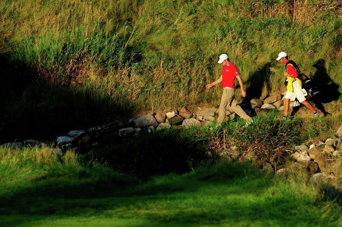 KOHLER, WI - AUGUST 14: Nick Watney and caddie Chad Reynolds walk on the 18th hole during the third round of the 92nd PGA Championship on the Straits Course at Whistling Straits on August 14, 2010 in Kohler, Wisconsin. (Photo by Stuart Franklin/Getty Images) *** Local Caption *** Nick Watney;Chad Reynolds