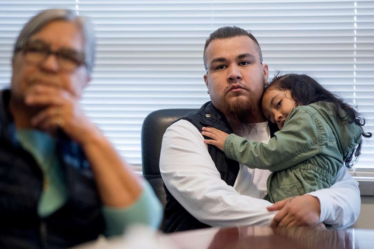 Daniel Miranda holds his daughter Ximena Miranda, 4, while supporting his mother and Ximena's mother Abigail Herrera of Richmond, who fell victim to a large rental scheme, during a meeting at the Richmond District Attorney's office in Richmond, Calif. Friday, January 31, 2020. Mercedes Gonzales, 25, of San Pablo, was indicted on 42 criminal counts in a real estate fraud case that stretched over three counties. Following a report from Chronicle columnist Otis Taylor on Gonzales' scheme and victim Martha Ochoa. Readers responded with donations, including a philanthropist who sent a check for $5,000. After 22 more victims were identified by the district attorney's office, the philanthropist compensated them as well.