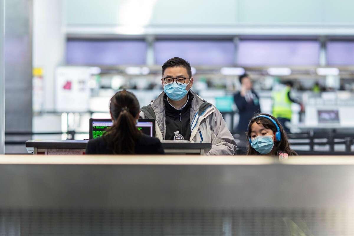 Passengers check in at China Eastern airlines at SFO on Friday, February 7, 2020 in San Francisco, Calif. SFO and its businesses have seen a 2.5% reduction in total passenger traffic and flight cancellations to China because of the coronavirus outbreak.