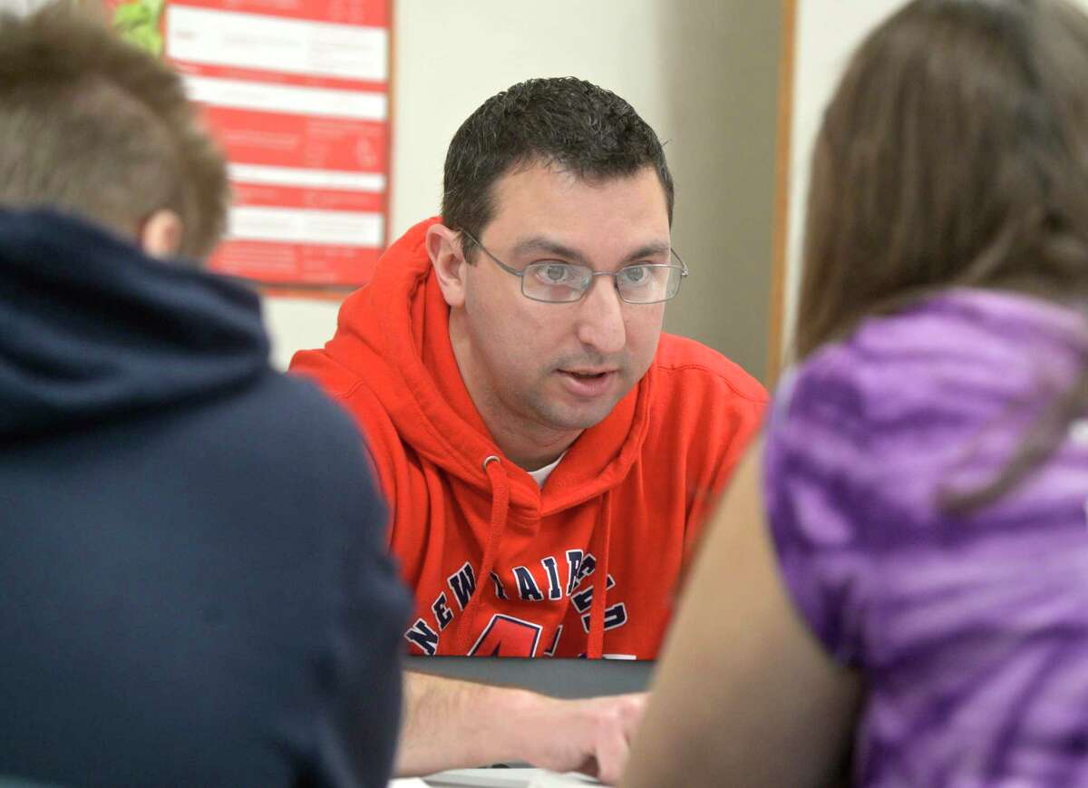 Math teacher Colin Usher works a group of students in his eighth grade math class. New Fairfield Middle School, Friday, February 7, 2020, in New Fairfield, Conn.