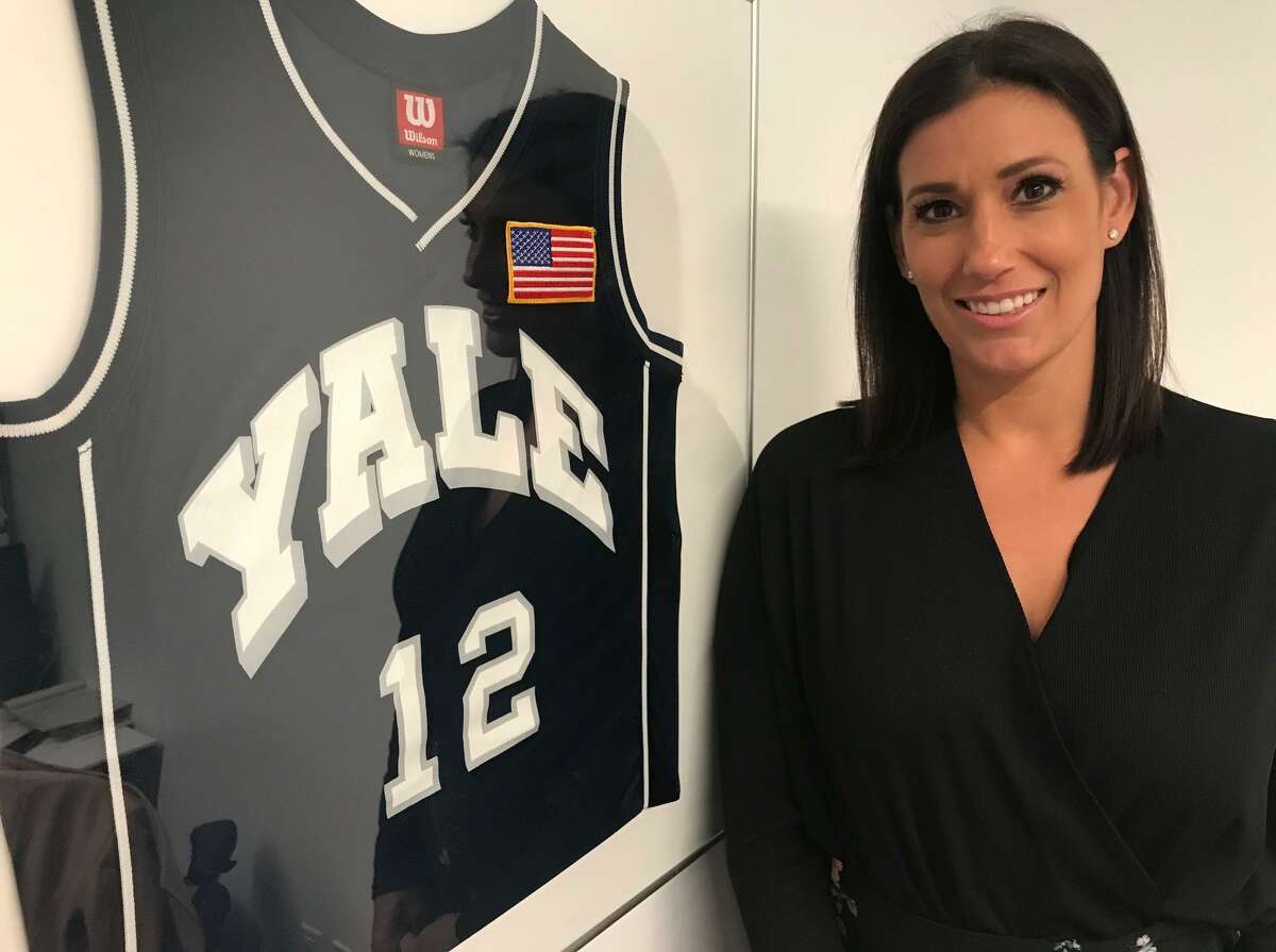 Brynn Gingras next to her Yale women’s basketball jersey hanging in her CNN office