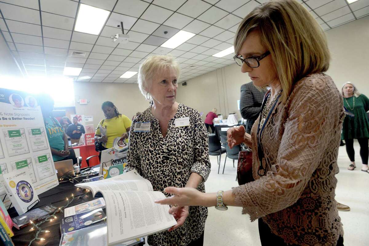 Kay Briscoe with Houghton Mifflin Harcourt shows highlights of a textbook to West Brook High School teacher Denise Clement during an informative session with publishers at the BISD Administration Building Tuesday as the district continues the process of textbook selection for the upcoming school year. Photo taken Tuesday, Jan. 14, 2020 Kim Brent/The Enterprise