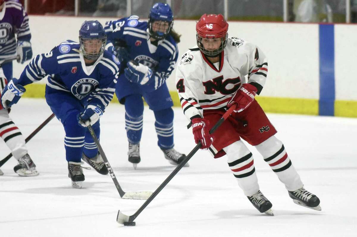 New Canaan's Kaleigh Harden (4) skates with the puck during a girls ice hockey game against Darien at the Darien Ice House on Saturday, Jan. 4, 2020.