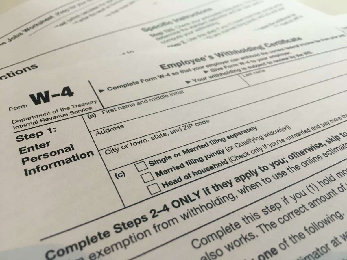 This Wednesday, Feb. 5, 2020 photo shows the W-4 form in New York. The IRS has introduced a new Form W-4 that must be used by all employers in 2020 to better accommodate recent changes to the tax law. A It's the biggest overhaul of the form in decades. It can require a bit more legwork but in return, the IRS says it will yield more accurate results. (AP Photo/Patrick Sison)