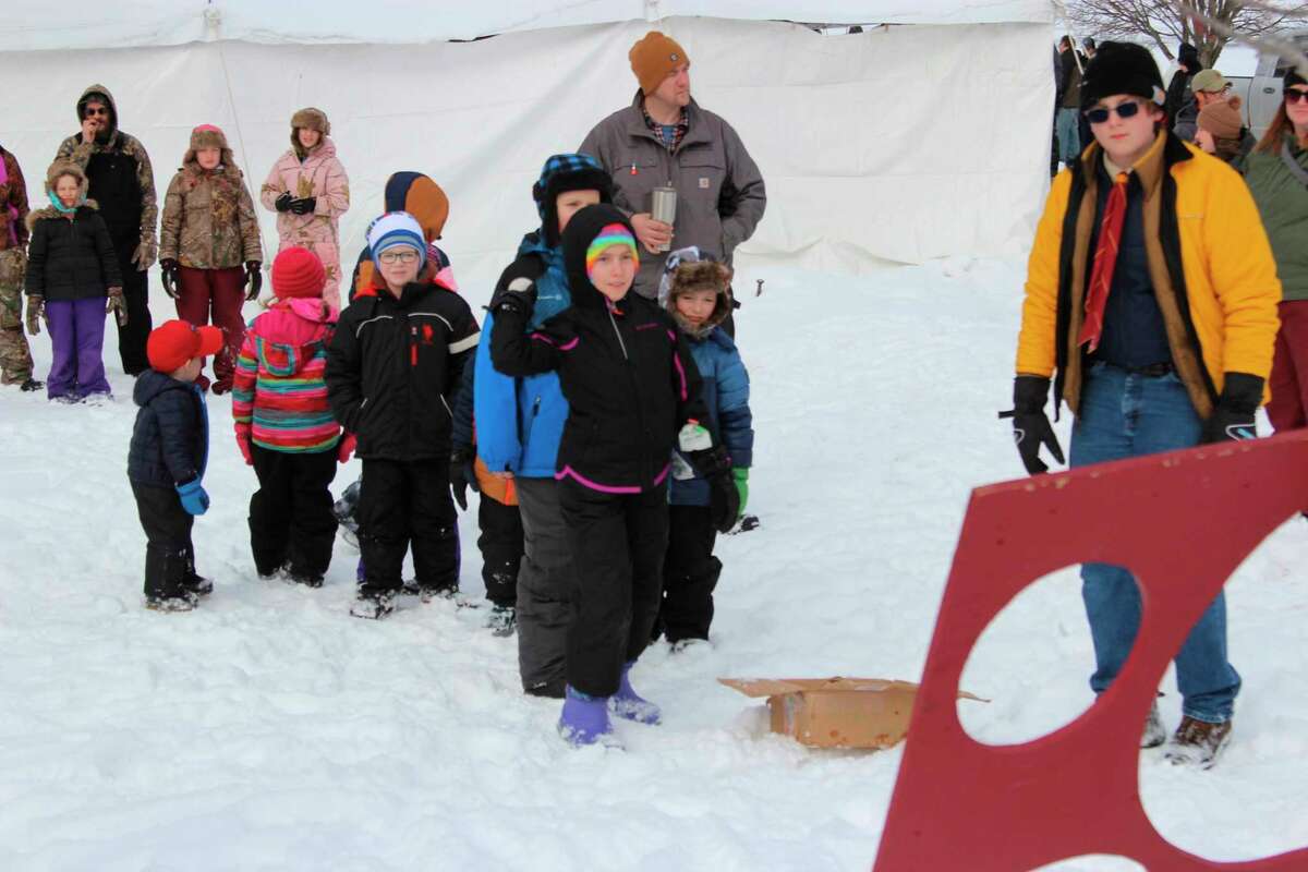 A young competitor takes aim in the "snowball" throwing contest. (Photo/Colin Merry)