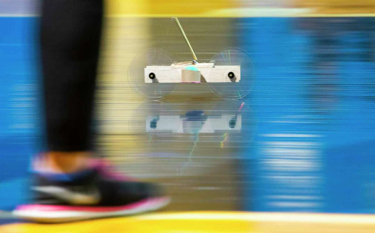 A mouse trap-powered car races across the gymnasium floor during a competition hosted by ExxonMobile and SECME, an organization committed to bring more underrepresented students into the engineering field, Saturday, Feb. 8, 2020, at Holland Middle School in Houston.