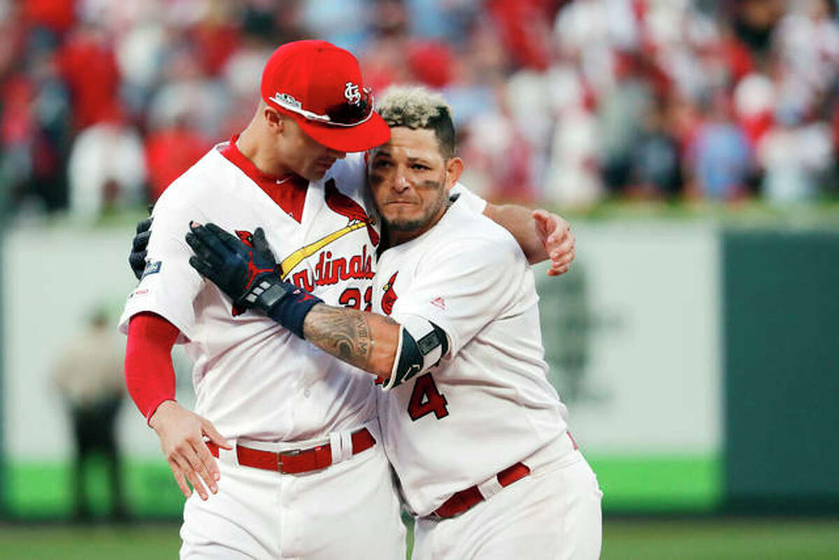 Cardinal pitcher Jack Flaherty, left, celebrates with Yadier Molina after a sacrifice fly by Molina that defeated the Atlanta Braves in Game 4 of the National League Division Series last October in St. Louis. The Cardinals head to spring training in Florida beginning Feb. 12.