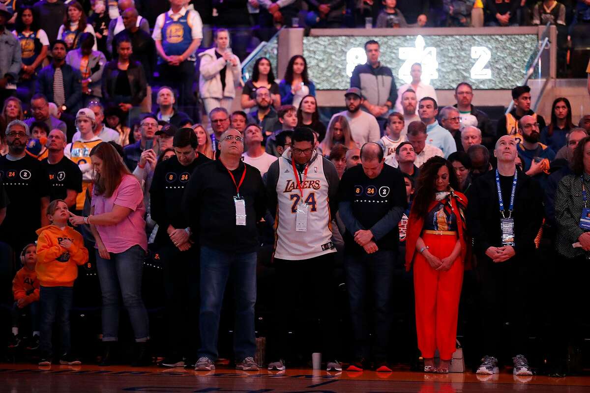 Fans during moment of silence for Kobe Bryant before Golden State Warriors play Los Angeles Lakers during NBA game at Chase Center in San Francisco, Calif., on Saturday, February 8, 2020.