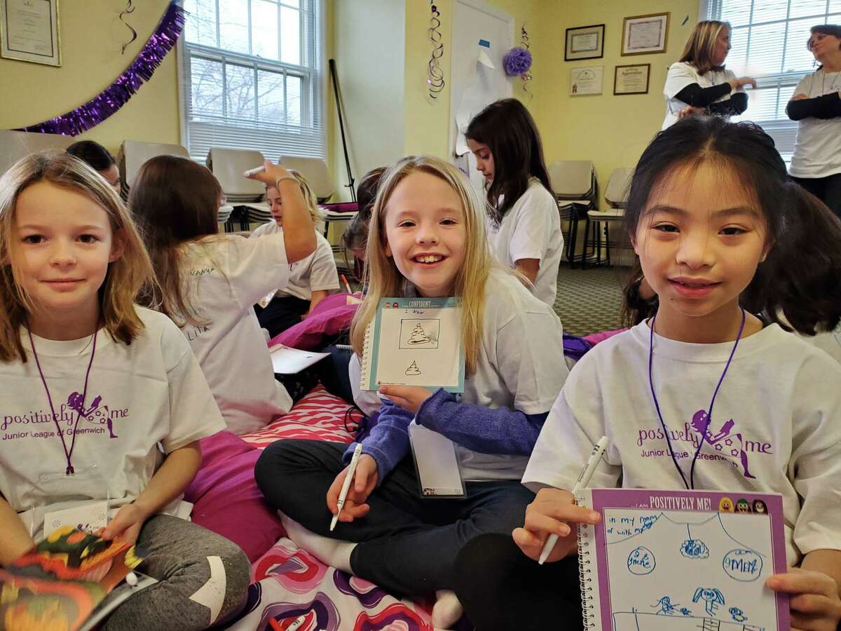 Last weekend’s Positively Me event was designed to give 8- and 9-year-old girls the skills to be confident, make good decisions, be assertive, express themselves and cope with peer pressure and bullying. From left, Evie Kelly, Rose McLean and Molly Moy demonstrate their work in their Positively Me self-ref;ection notebooks about how they deal with their emotions.