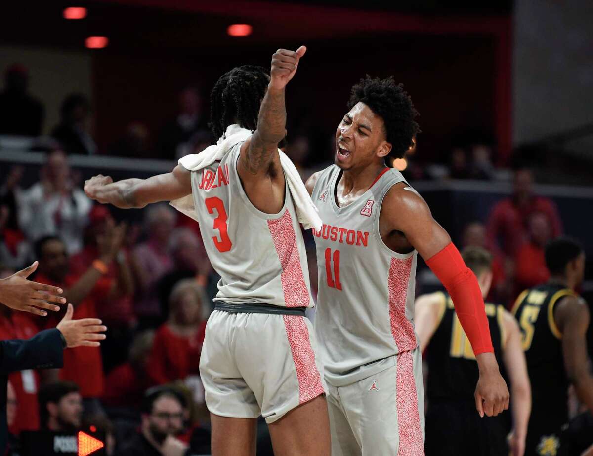 Houston guard Nate Hinton (11) and guard DeJon Jarreau celebrate during a timeout during the second half of an NCAA college basketball game against Wichita State, Sunday, Feb. 9, 2020, in Houston.