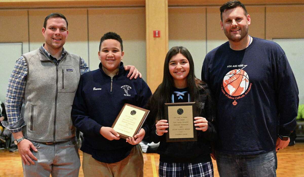 Trevor Ugolyn, left, congratulates award winners Connor Bowron and Lauren Davis at Our Lady of Fatima Academy on Jan. 31. Athletic Director Robert Benedetto is at right.