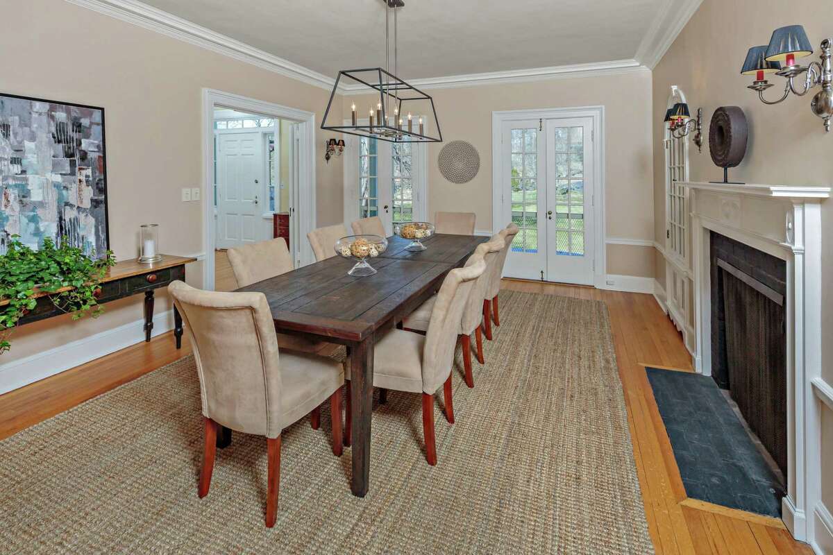 In the formal dining room there is a fireplace, two built-in china cabinets, and French doors to the veranda.