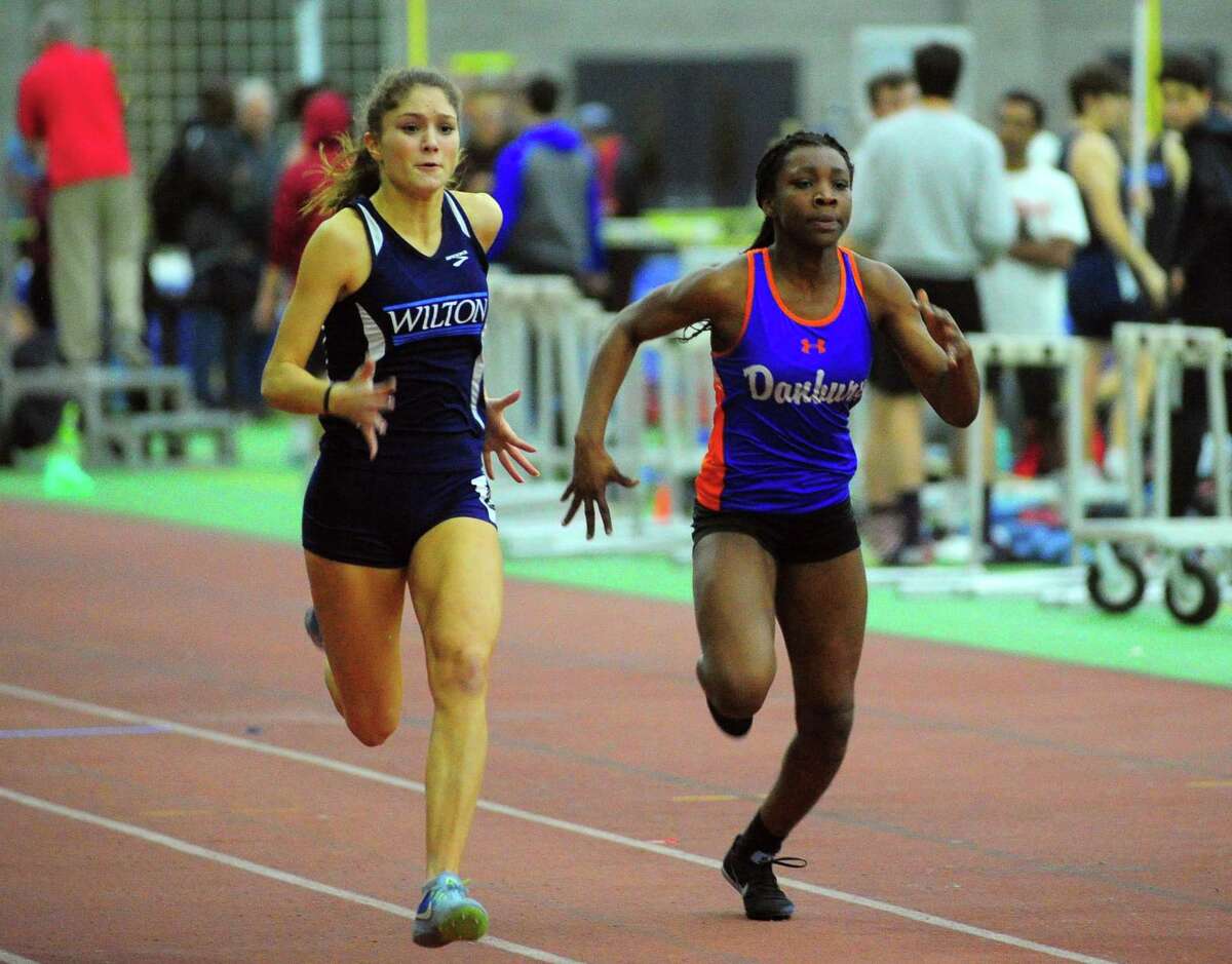 Wilton's Shelby Dejana (left) and Danbury's Florence Dickson compete in the 55-meter dash finals at the FCIAC girls indoor track championship in New Haven last Thursday. Dejana won the race.