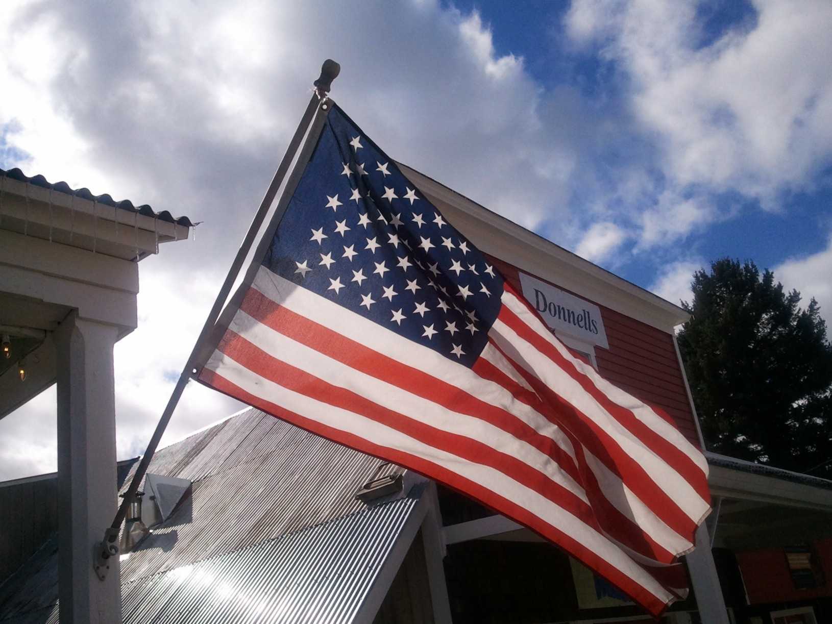 FedEx driver spotted picking up, folding fallen American flag