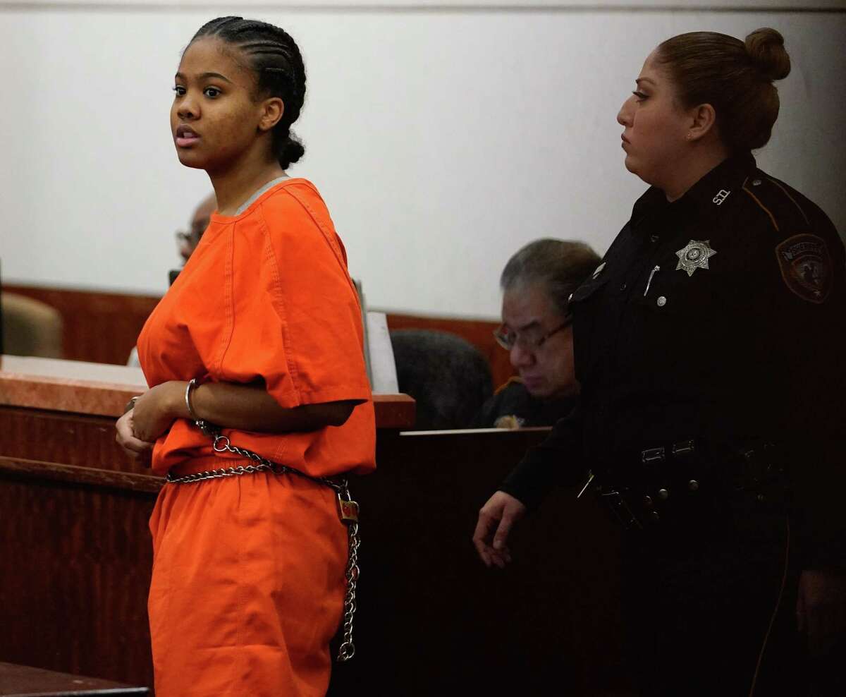 Keona Mouton, 17, is escorted into court for an appearance Monday, Feb. 10, 2020 in Houston. She's being tried as an adult in the murder of Delindsey Mack, who police say she led to a spot near Lamar High School where he would be ambushed by shooters on Nov. 13, 2018. She was 16 at the time of the shooting.