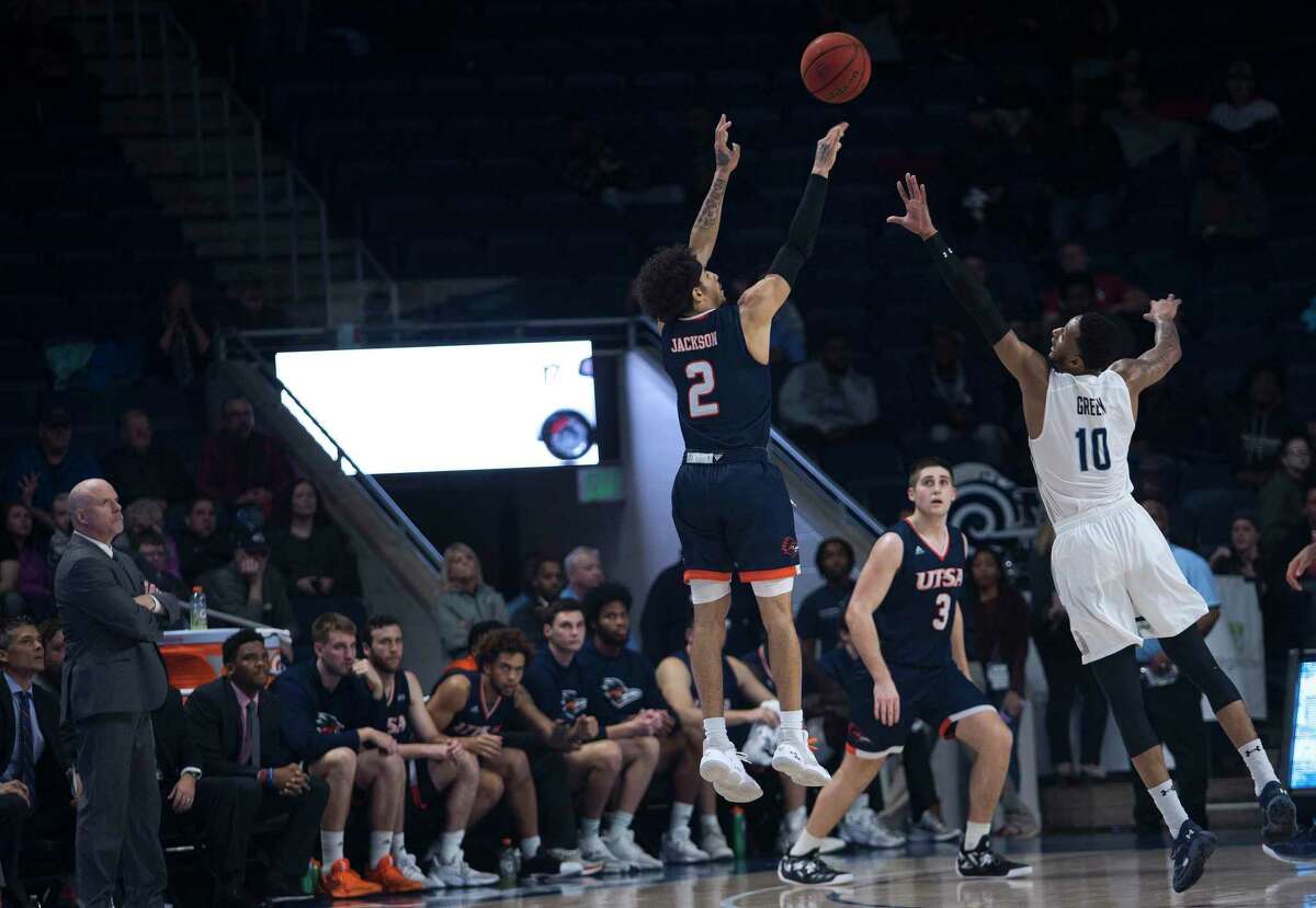 In overtime, UTSA's Jhivvan Jackson (2) makes a three-point basket over the defense of Old Dominion's Xavier Green during overtime of an NCAA college basketball game in Norfolk, Va., Thursday, Feb. 6, 2020. (L. Todd Spencer/The Virginian-Pilot via AP)