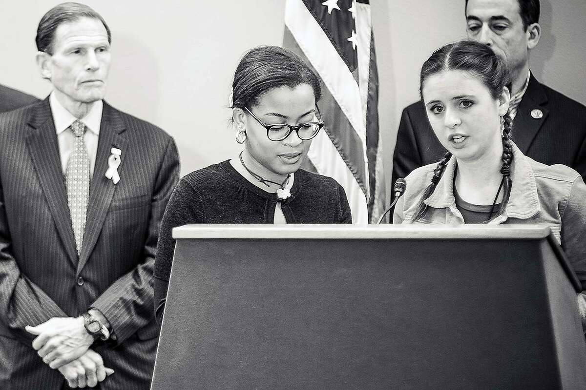 Danielle Johnson, left, and Natalie Barden speak at a press conference as U.S. Sen. Richard Blumenthal look on.