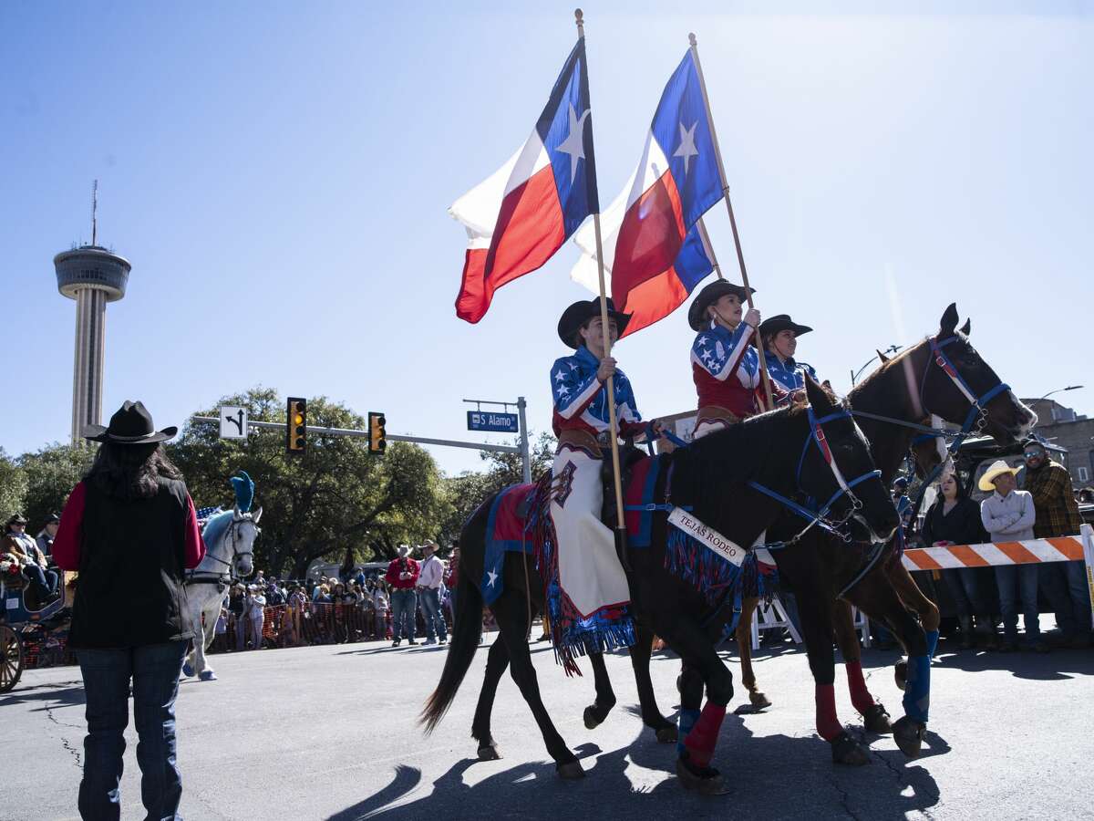 Riders carrying the Texas State Flag make their way through downtown San Antonio during the annual cattle drive on Saturday, February 1, 2020. This weekend kicks off the San Antonio Stock Show and Rodeo.