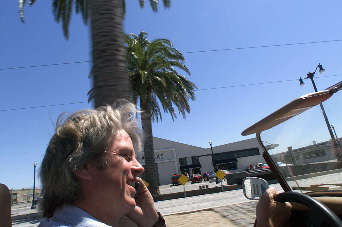 FILE - Bill Fink, Morgan guru in the Bay Area talks to a customer as he cruises around San Francisco.