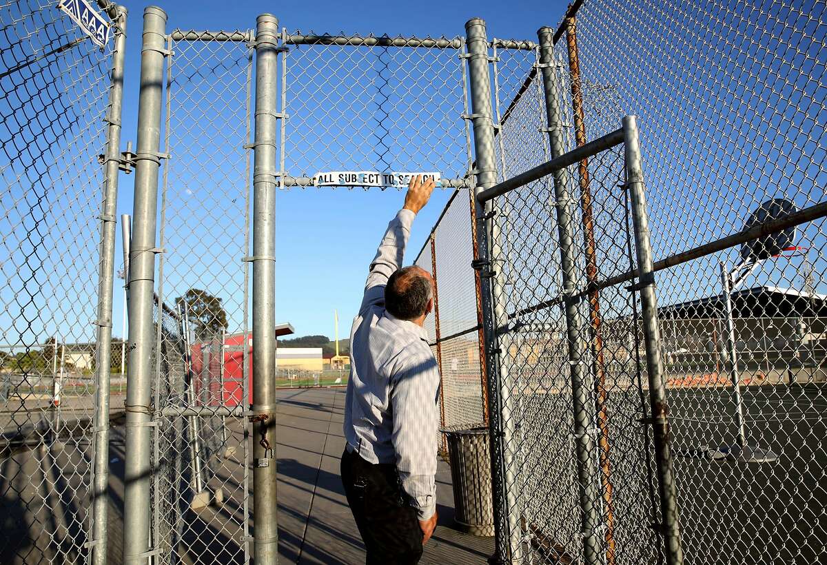 Principal Jose De Leon straightens a sign at Richmond High School, located at 1250 23rd St., in Richmond, Calif., on Thursday, February 6, 2020. Prop. 13 would authorize a $15 billion bond for school facilities.