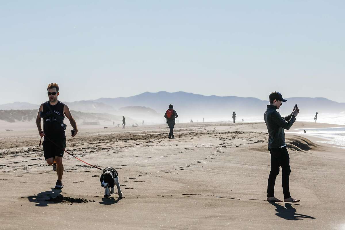 People enjoy Ocean Beach on a sunny day on Monday, Feb. 10, 2020 in San Francisco, California.
