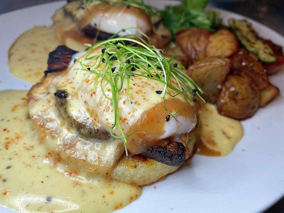 Eggs Benedict with espresso pork belly and hollandaise sauce is part of the menu at Full Belly Cafe and Bar, which is reopening Oct. 5 in Stone Oak. Photo: Mike Sutter /Staff File Photo