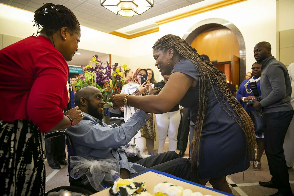 Corey Cunningham shares cake with new wife Tyyisha Marie Evans after their wedding ceremony in the Weiss Chapel at Houston Methodist Hospital on Monday, Feb. 10, 2020. In Nov. 2019, Cunningham was diagnosed with glioblastoma, an incurable brain cancer, just one month after Evans learned she was breast cancer free.