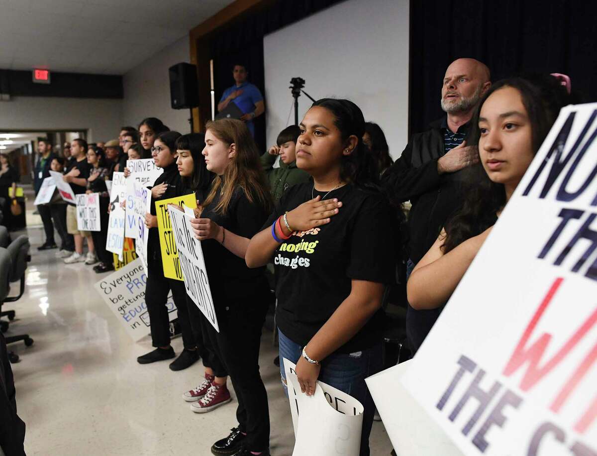 SAISD students recite the Pledge of Allegiance before speaking about the district's Bill of Rights at a board meeting Feb. 10. The students want more representation and some expressed concern about police on campus.
