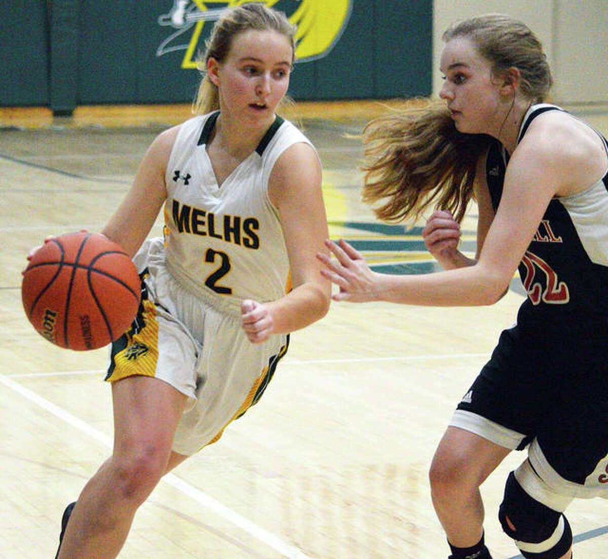 Metro-East Lutheran’s Chloe Langendorf, left, drives to the basket during Monday’s first-round game against Bunker Hill at the Class 1A MELHS Regional.
