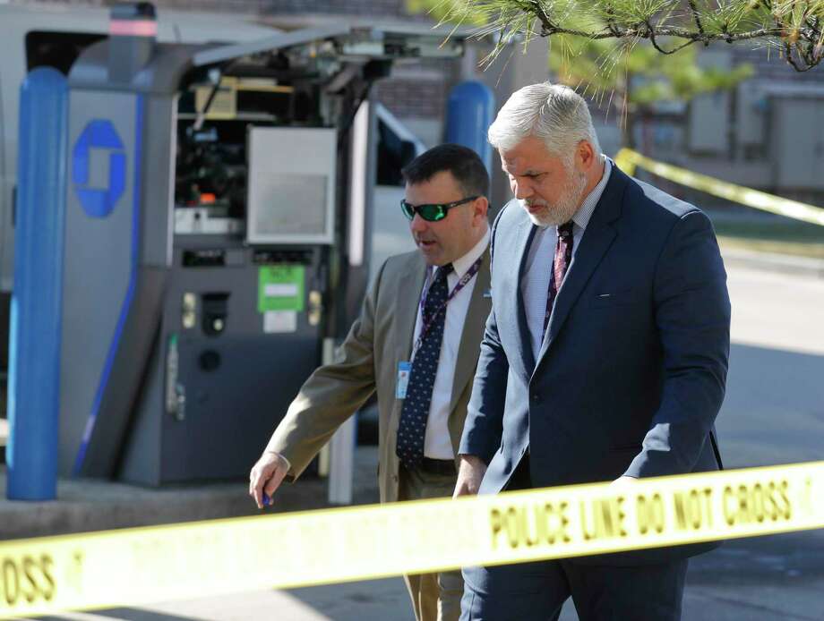 Montgomery County District Attorney Brett Ligon, right, walks the scene with Major Crimes Division Chief Rob Freyer after two men attempted to rob a Brinks security employee while servicing an ATM at a Chase bank, Tuesday, Nov. 19, 2019, in Willis. The employee shot and killed one suspect, while law enforcement is searching for the other who fled. Photo: Jason Fochtman, Houston Chronicle / Staff Photographer / Houston Chronicle